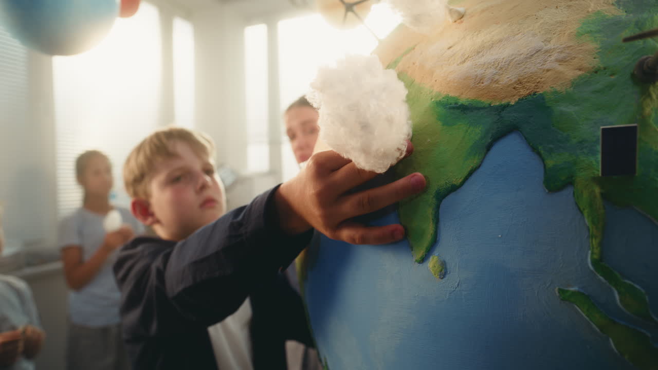 Environmental Science Lesson Primary School Girl Attaching Miniature Cloud to Earth Model