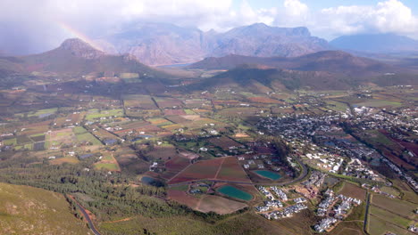 stunning reveal from pass over franschhoek, rainbow and mountains