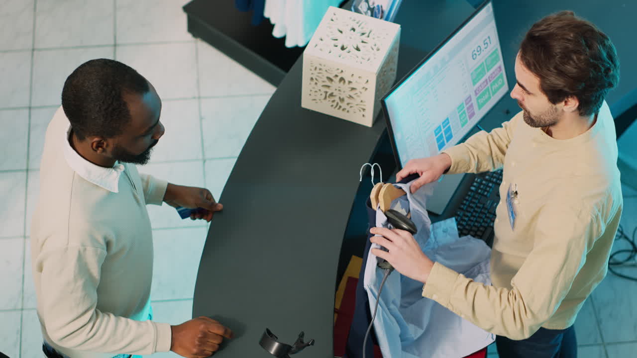 Customer making a purchase at a clothing store