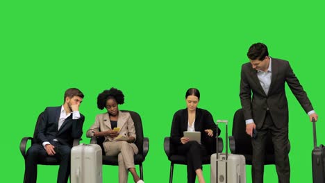 business people at the waiting area in the airport on a green screen, chroma key