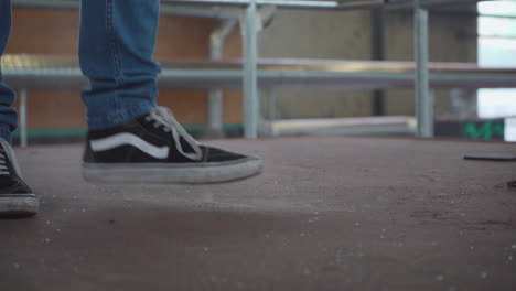 Person-kicking-up-dust-on-old-floor,-closeup-slow-motion