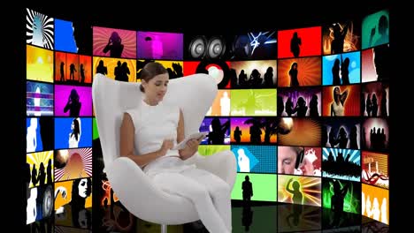 woman sitting in a white chair and videos on screens