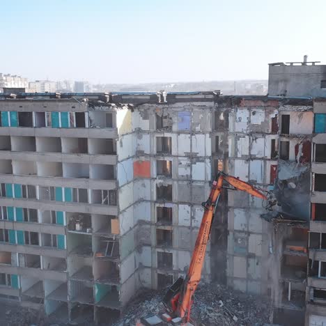 dismantling of a house. destroying old house with bulldozer mechanical arm
