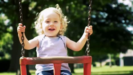 child playing on a swing set