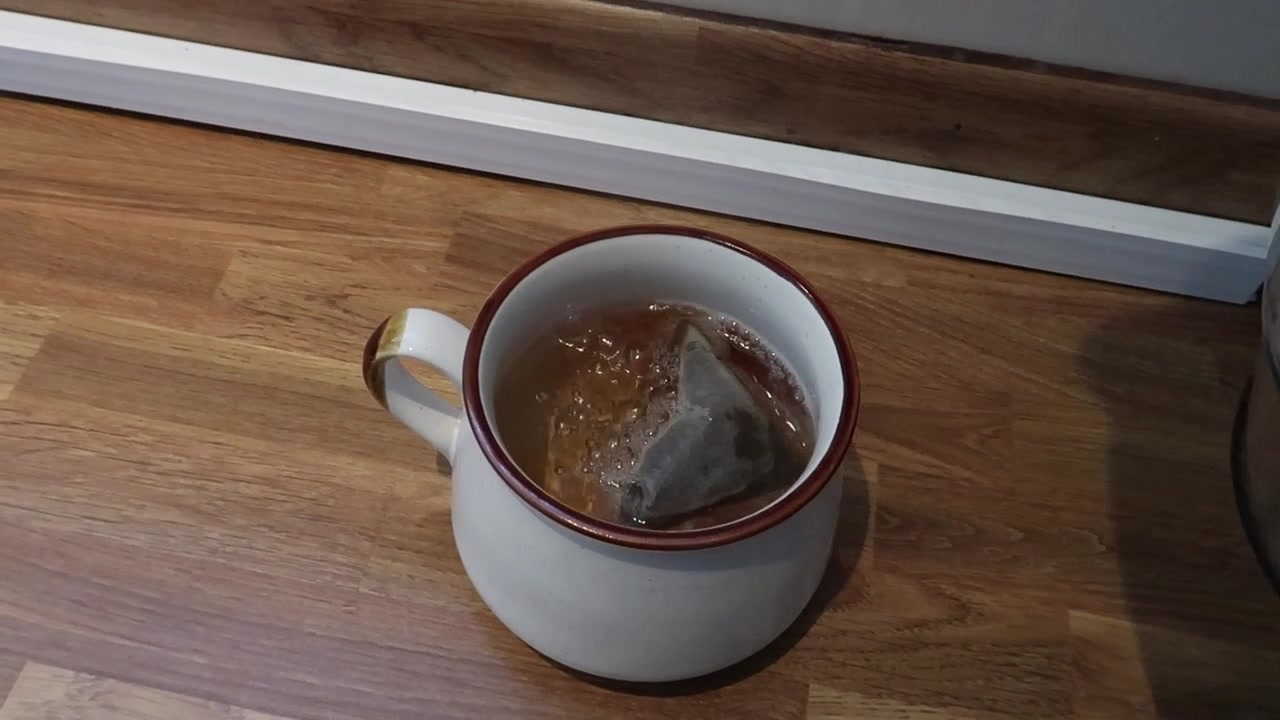 Water from the kettle being poured into a mug.