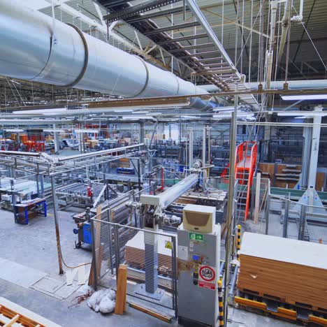 parquet factory indoors. metal constructions for processing wood inside the manufacture of furniture. modern robotic equipment in a plant.