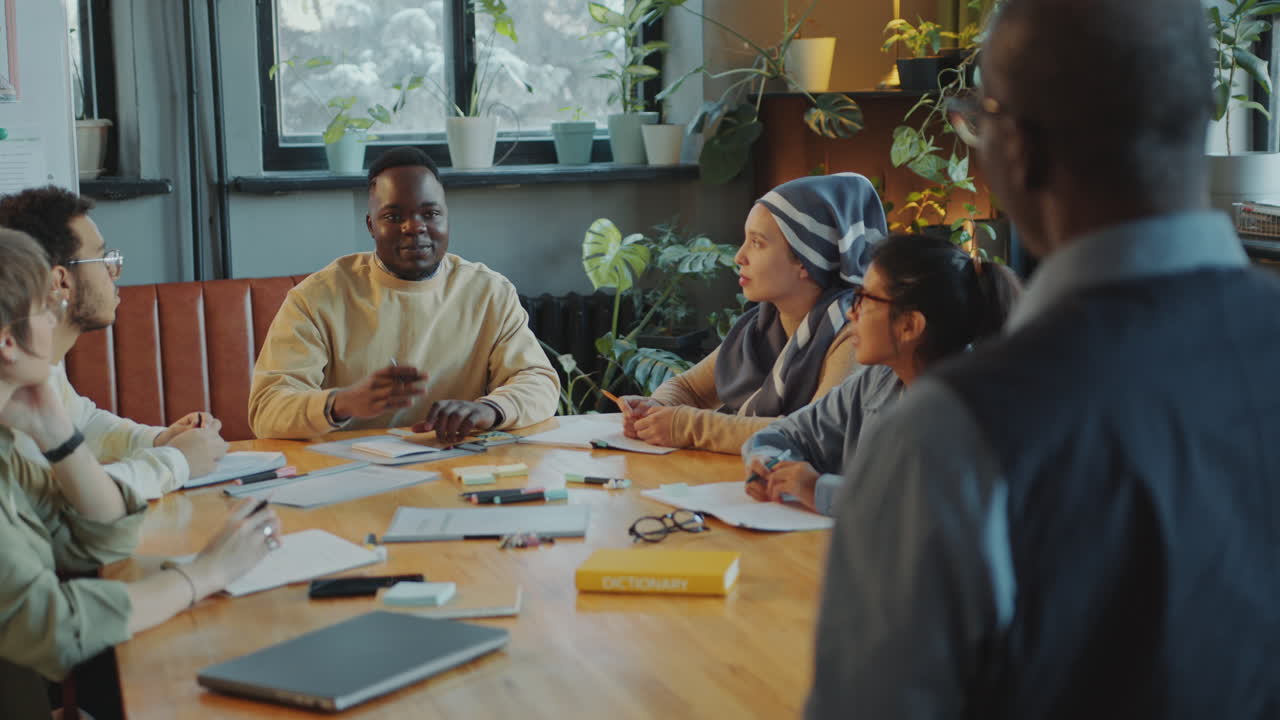Student Asking Teacher a Question on Lesson in School for Immigrants