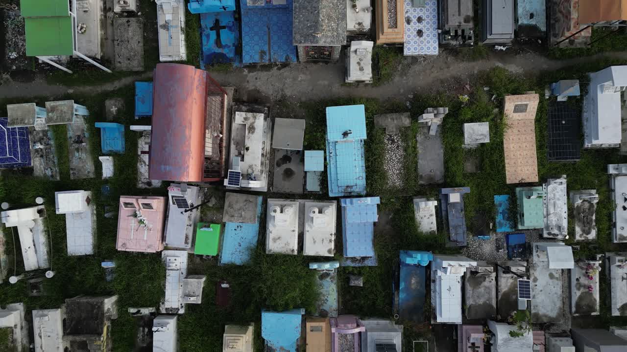 Aerial view of a cemetery in Dili, showcasing a variety of tomb designs and colors