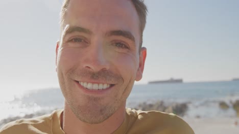 Portrait-of-young-man-on-a-beach-smiling