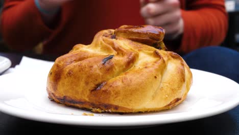 Preparing-to-eat-a-tasty-Qassatat,-otherwise-known-as-a-Pastizz,-in-Malta