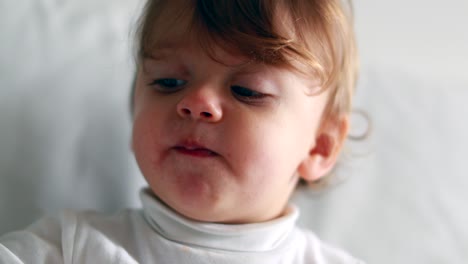 cute baby child eating blueberry snack. portrait of one year old toddler snacking