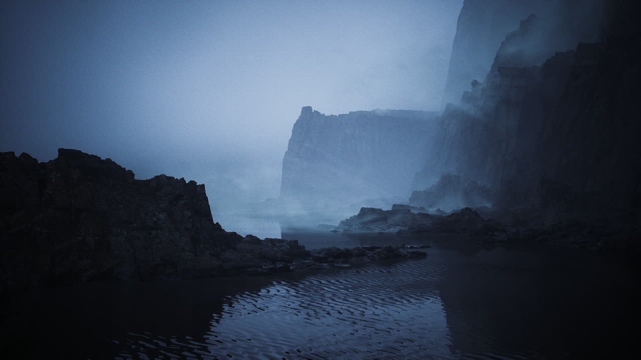 Foggy coastline with rocky cliffs and gentle waves during twilight