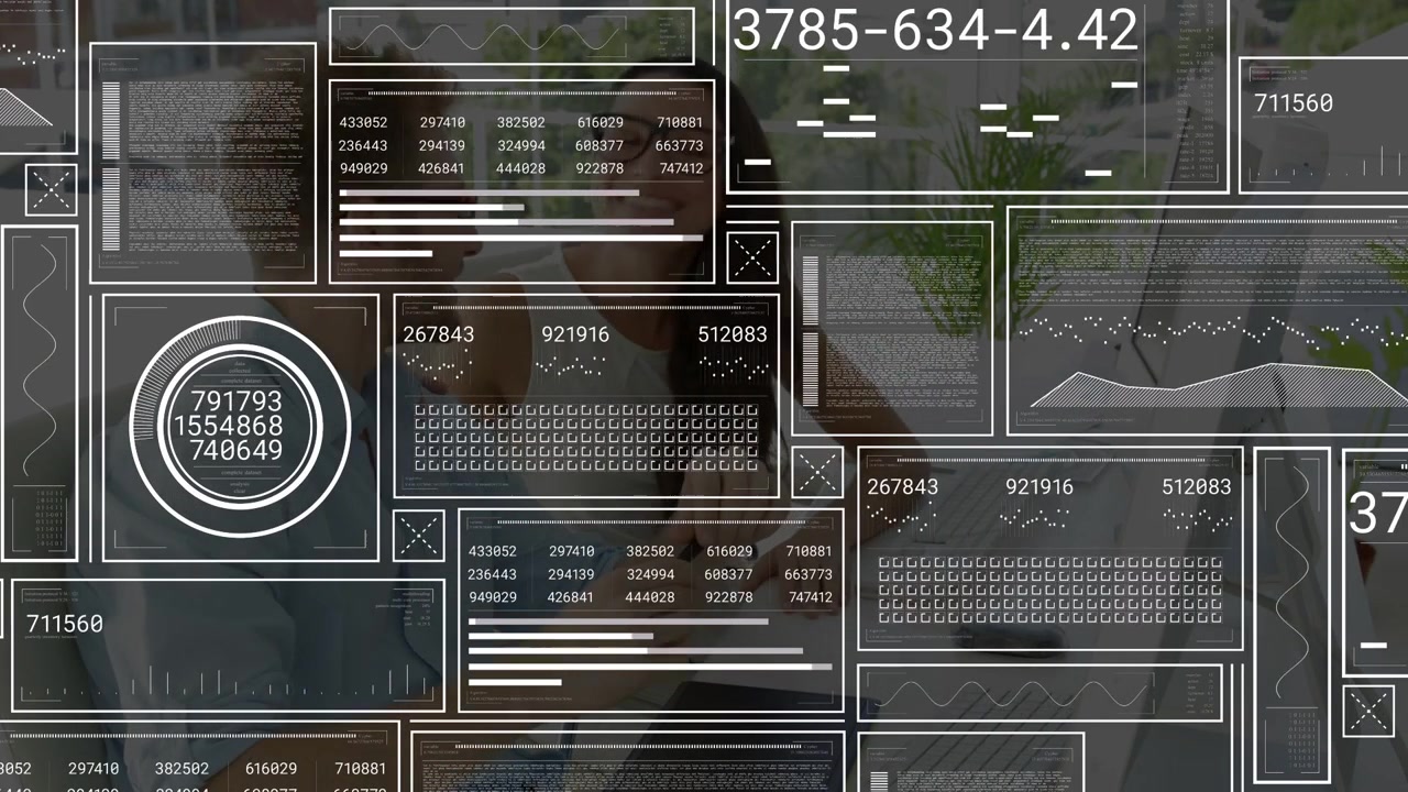 Male and female tech coworkers sitting, HUD overlay fading in while reviewing laptop, phone metrics