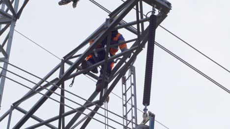 electrician climbs on electric poles to install and repair power lines