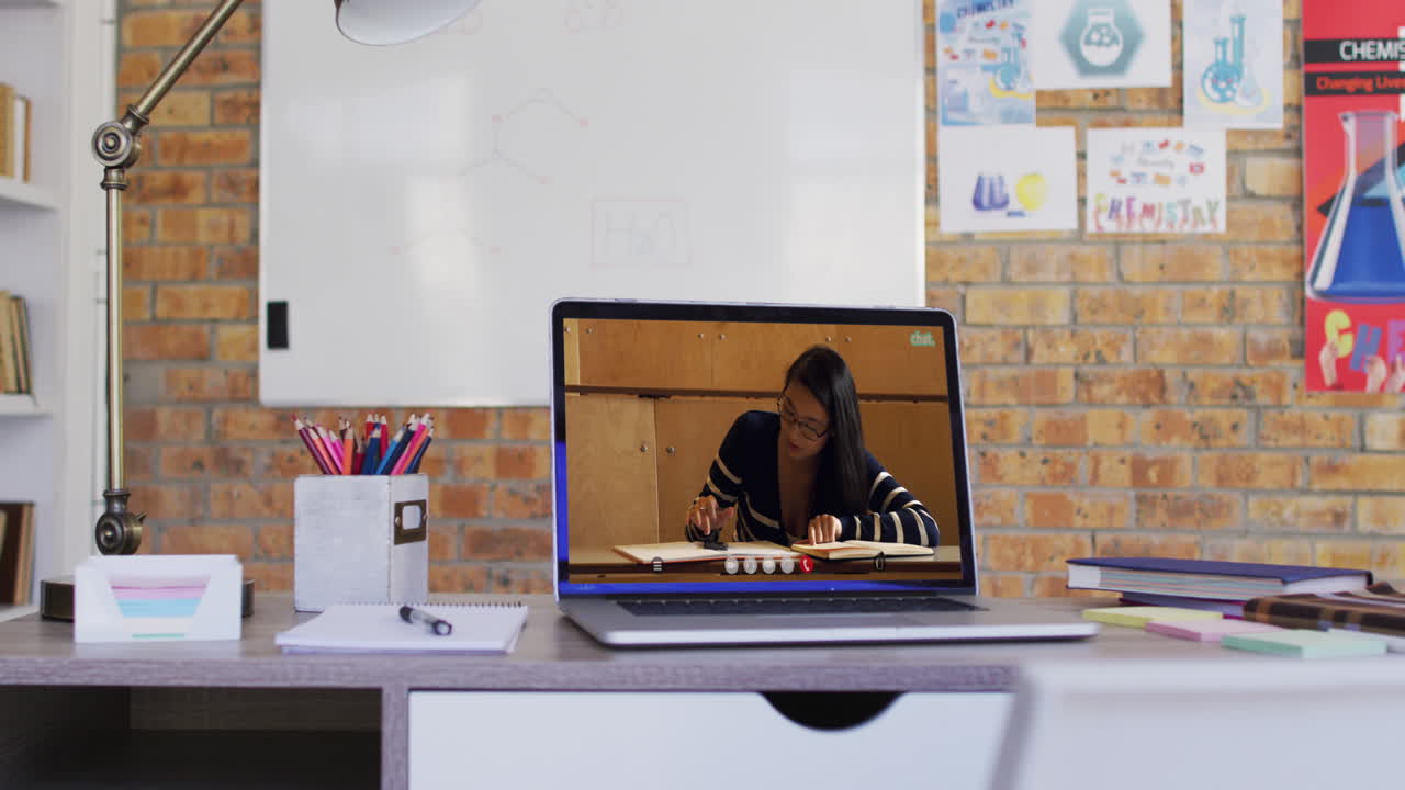 Biracial female student learning displayed on laptop screen during video call