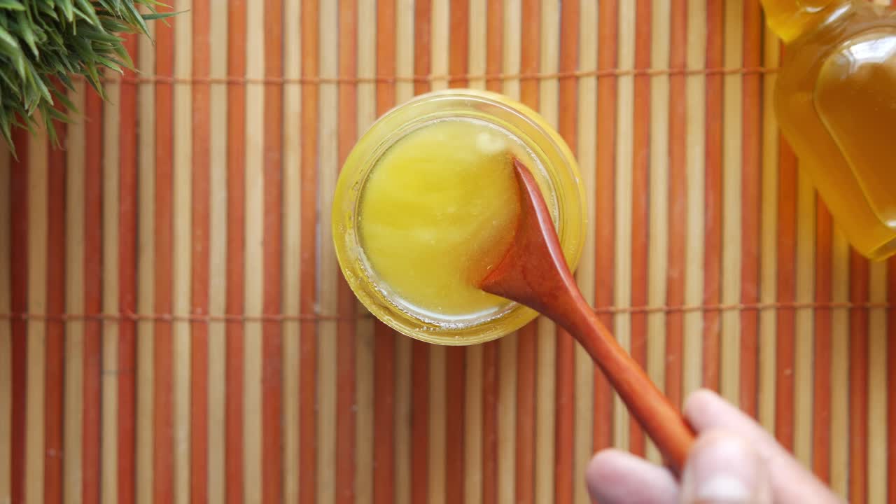 Ghee being scooped from a jar