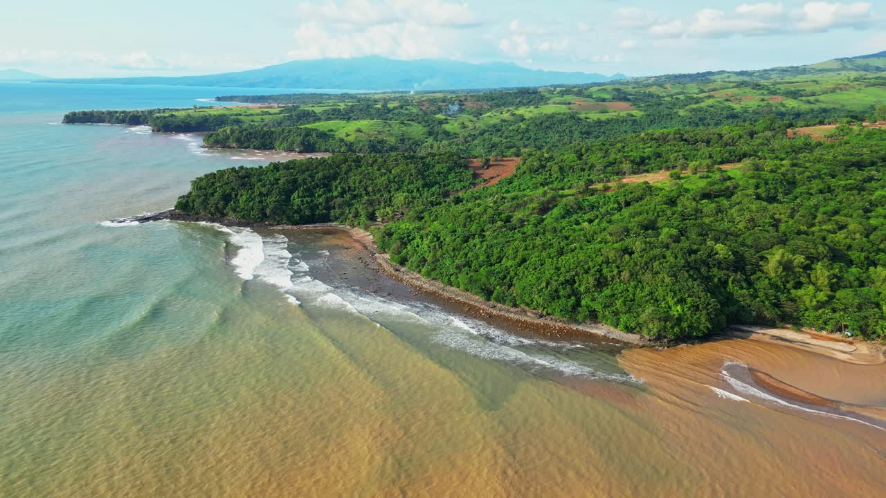 Elevated aerial capturing rolling hills covered in greenery above the coastline, with scenic views of the shoreline and tropical landscape near Quinawan Beach in Mariveles, Bataan, Philippines