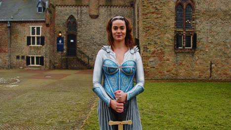 attractive fantasy warrior princess standing in front of medieval castle and talking