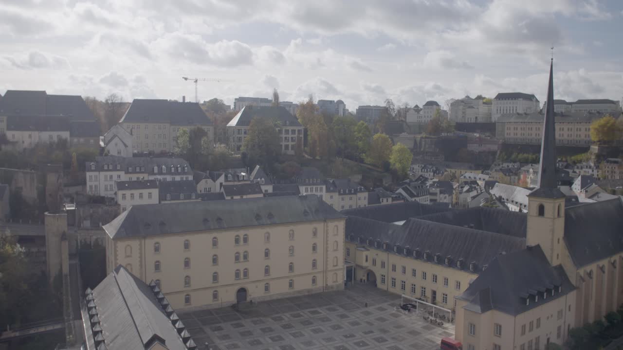 Luxembourg cityscape with historic buildings and greenery, panning shot
