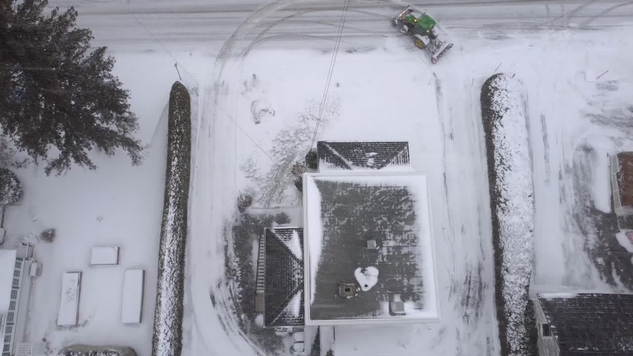 Snow plow clearing road infrastructure heavy Canada winter snowfall, aerial view