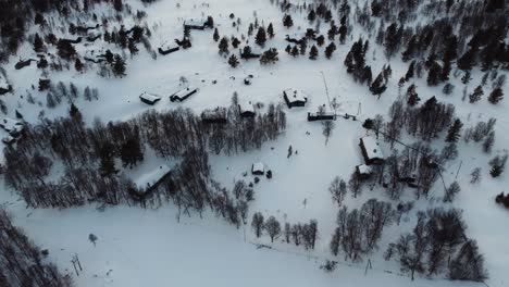 Flyover-Snow-Covered-Cabins-Near-Rondane-National-Park,-Norway