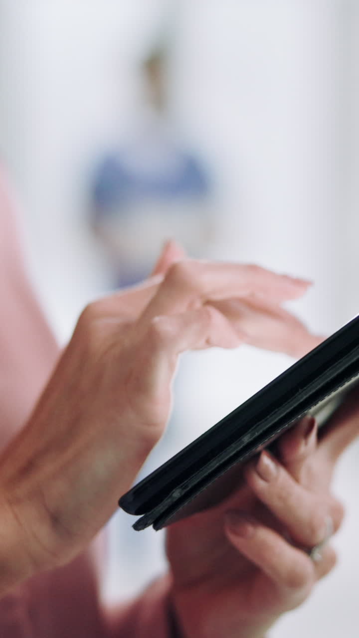 Close-Up of Hands Tapping and Swiping on a Digital Tablet