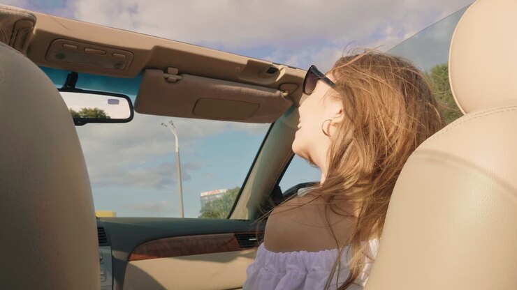 Woman enjoying a drive in a convertible car