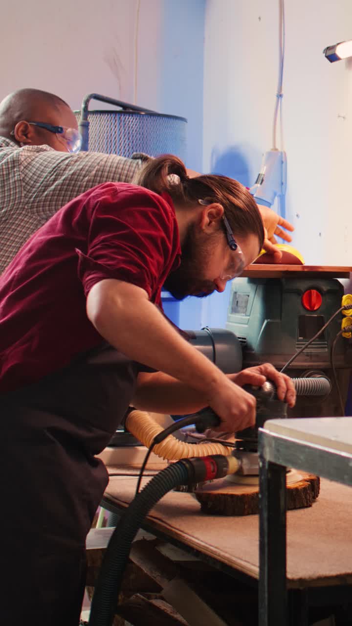 Skilled Woodworker Sanding Wood with Power Tool in Workshop