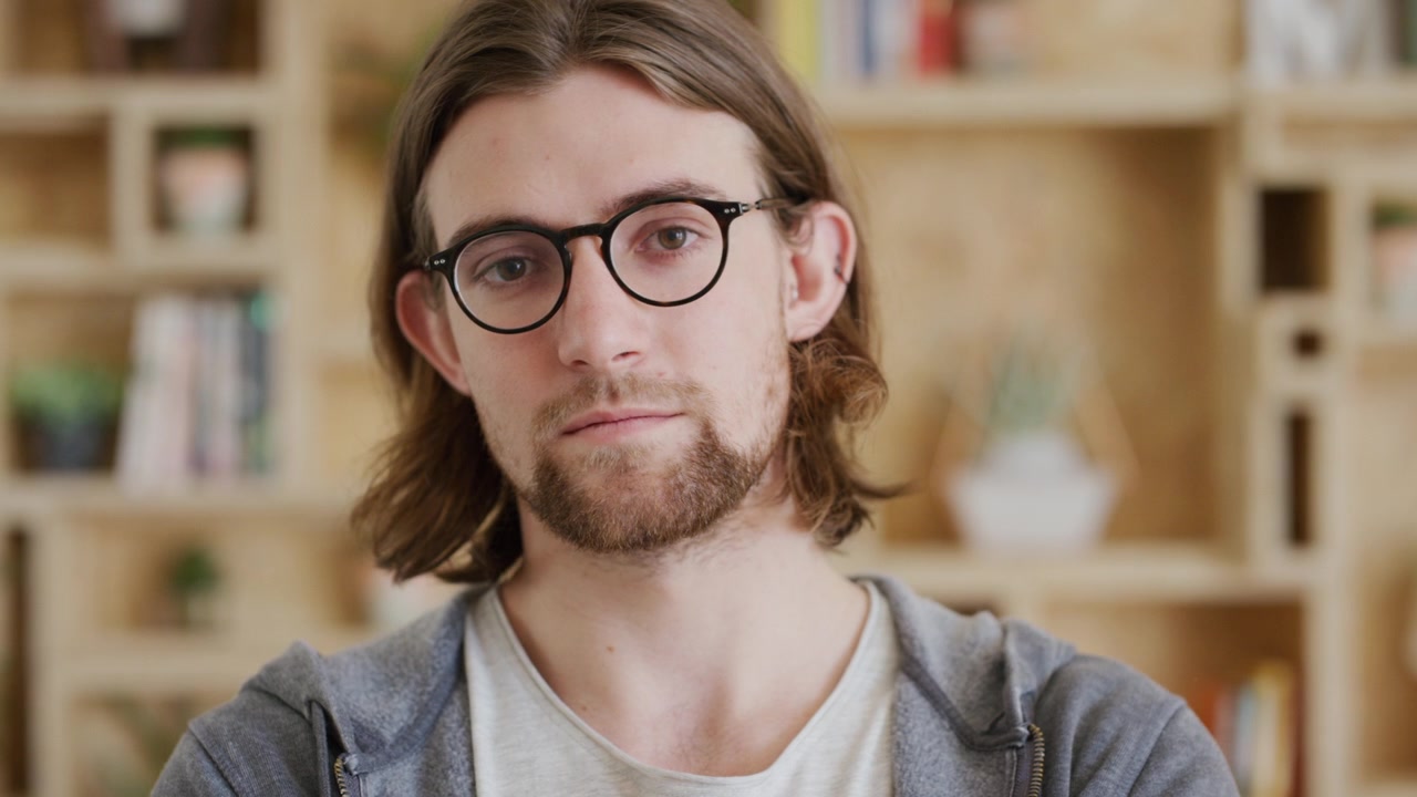 Portrait of a Young Man with Glasses Looking at Camera