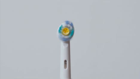 white electric toothbrushes with rotating head on and off. slow motion