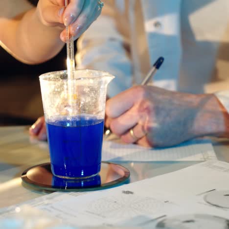 two young scientists working together in research laboratory testing chemicals and bacteria. concept of science