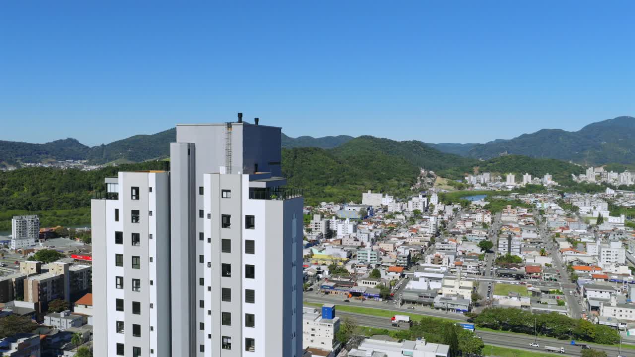 Smooth aerial fly at Balneário Camboriú district near modern high-rise apartment building, BR-101, Santa Catarina, Brazil