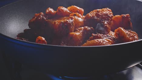 frying chicken breast fillet seasoned with herbs and spices in a pre-heated pan with oil