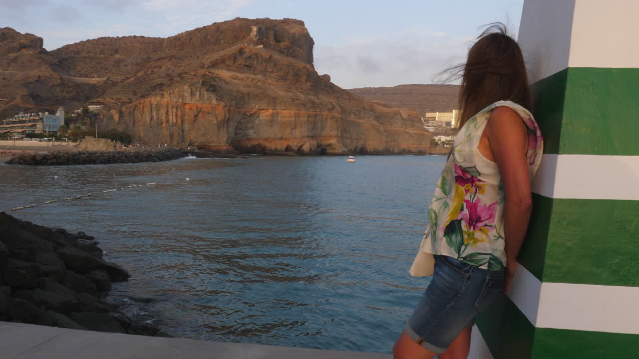 Woman enjoying the sunset in Puerto de Mogan, Gran Canaria