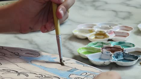 child painting with watercolors