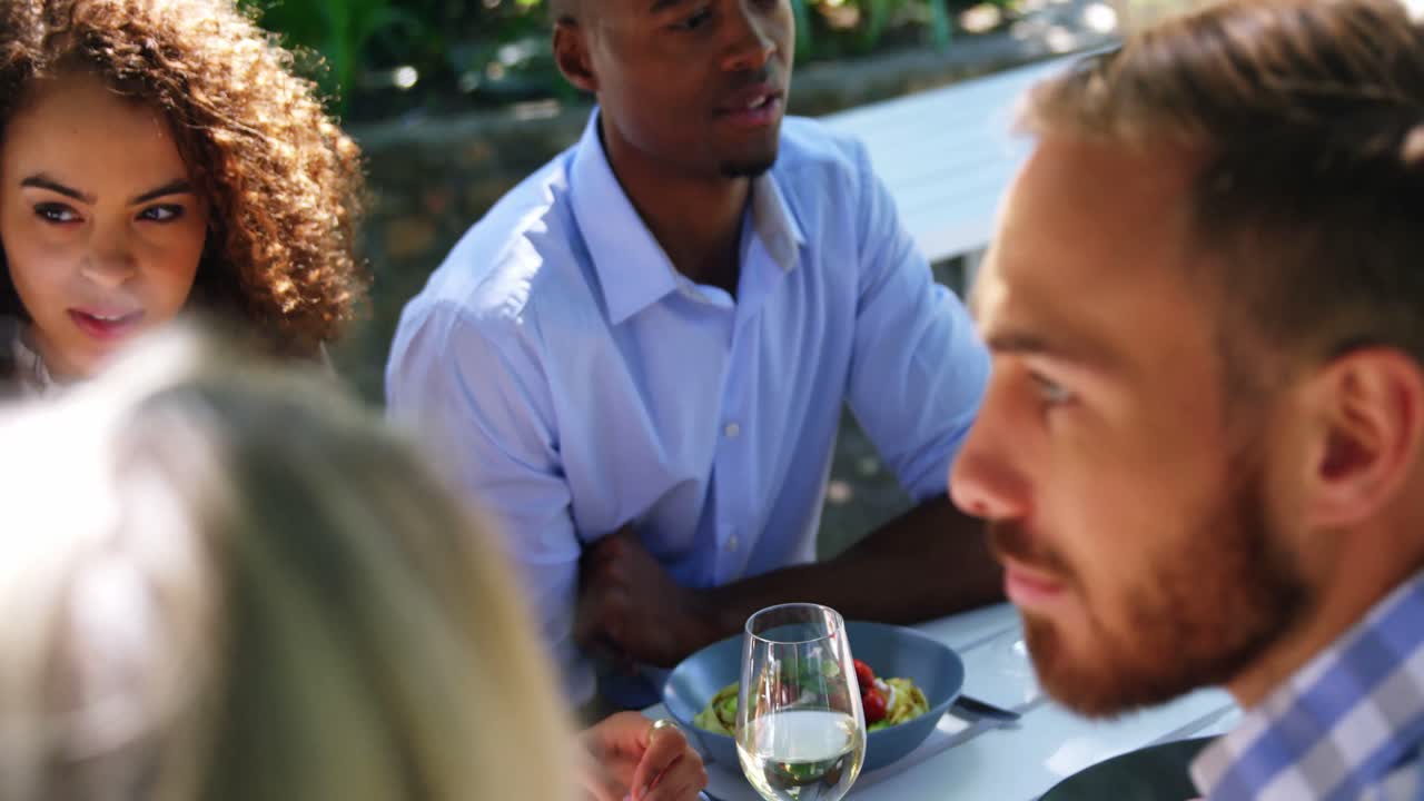 Friends interacting with each other at restaurant