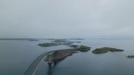 drone pullback view over storseisundet bridge along famous atlantic ocean road