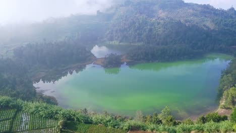 Aerial-drone-of-Telaga-Warna-in-Dieng-Plateau,-Wonosobo,-Indonesia