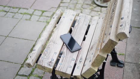 phone on a wooden park bench