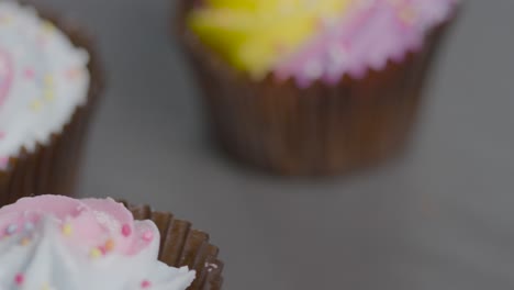 high angle close up shot of rotating sugary cupcakes