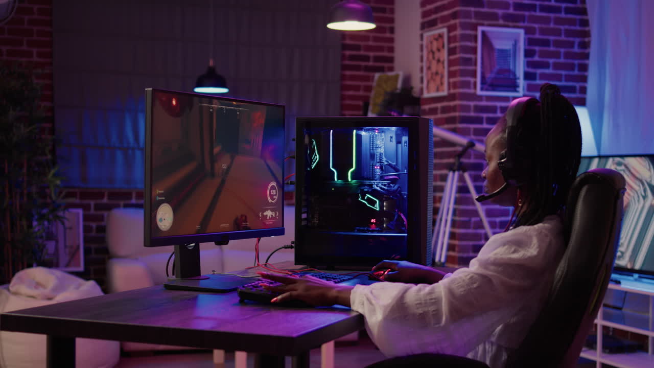 African american gamer girl playing online games using gaming pc setup spending relaxing time