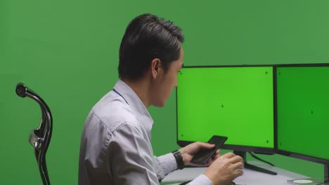 business person on phone at computer