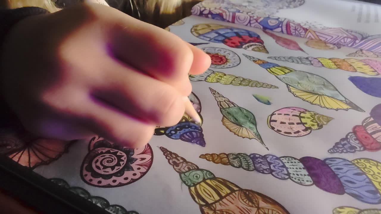 A young girl sits indoors coloring in her coloring book with focus and creativity. Cozy home environment, quiet moment of childhood imagination, learning and artistic expression