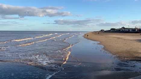 Warm-inviting-coastal-sunset-scene-with-people-walking-through-the-image