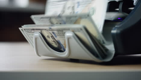 machine counting dollar bills close up. equipment for paper money calculation.