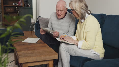 senior couple doing paperwork at home