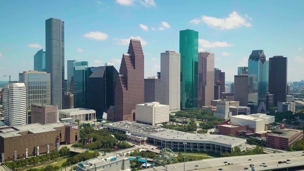 Aerial Shot of Downtown Houston in a sunny Day. Revealing Establishing Shot of Houston Downtown area, with tall building and freeway I45 North