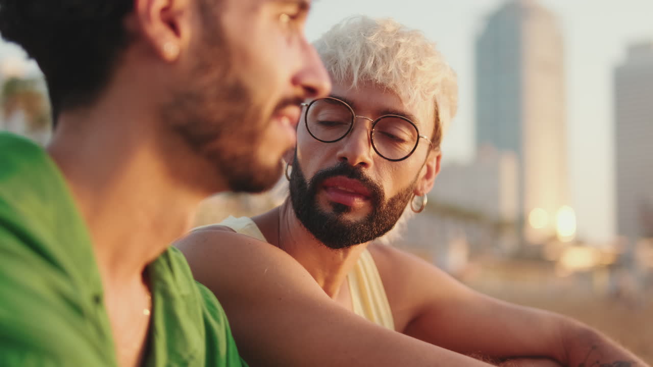 Two Young Men Having a Conversation Outdoors at Sunset