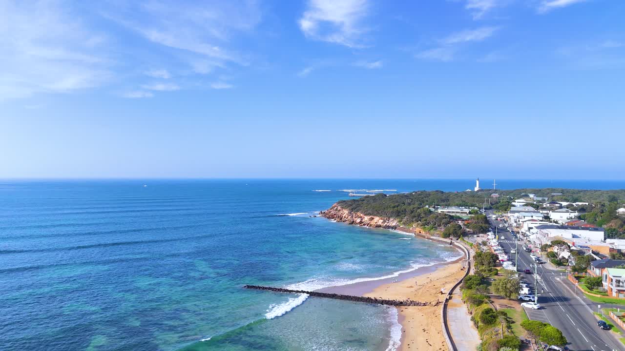 Aerial footage captures the scenic coastline of Point Lonsdale, Australia, showcasing clear skies, blue waters, and sandy beaches