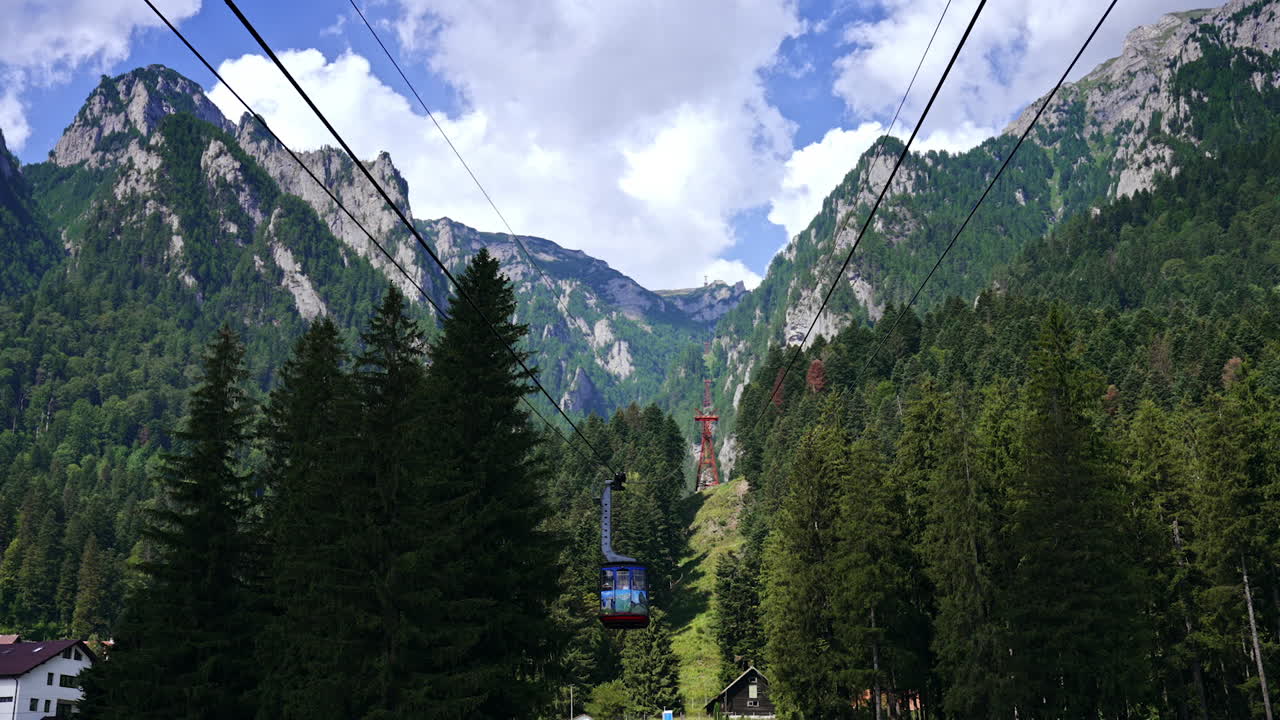 Cable car rides in mountains. Visitors enjoy a scenic cable car ride above lush trees, steep mountains, and a clear blue sky on a sunny day